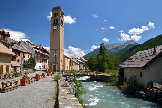 The hamlet Le Casset near the village Le Monetiers les Bains, Hautes Alpes (French Southern Alps), France, with the mountain stream La Guisane and the church 