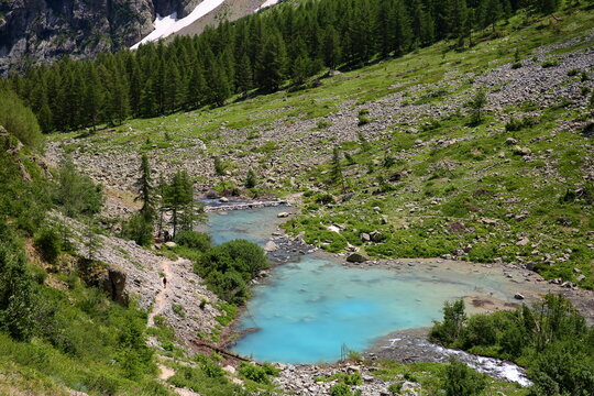 Lac de la Douche (Douche lake) surrounded by mountains and located in Ecrins National Park, Hautes Alpes, France.Picture taken from a hiking trail leading from the hamlet Le Casset towards Arsine pass