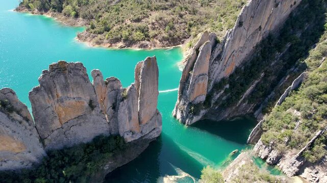 Bird's eye view aerial footage of Muralla de Finestres and Canelles Reservoir on spring day. Huesca, Spain.