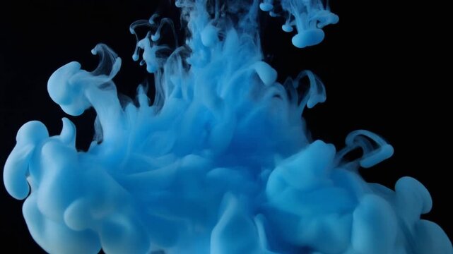 Blue ink dropping and blooming in clear water macro slow motion abstract dark background
