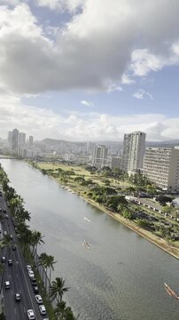 Outrigger boat or Canoe is a watercraft. Ala Wai Canal is an artificial waterway in Honolulu, Oahu, Hawaii. northern boundary of the tourist district of Waikiki. Coconut palm tree (Cocos nucifera)