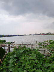 Floating fish farm on calm coastal waters. Aquaculture net pens for sustainable seafood production in overcast weather. © Sujan
