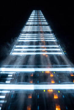 Server towers glowing with lights rising into the misty dark