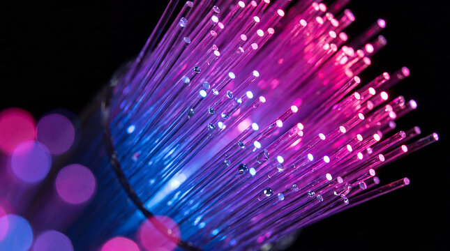 Macro view of glowing pink and blue fiber optic strands