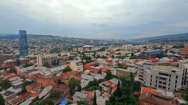 Old Tbilisi rooftops spread across the historic district beside new construction, documenting architectural preservation, urban renewal and property development in Georgias expanding capital.