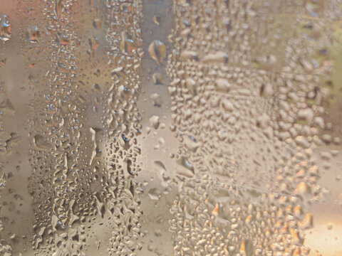 A professional high-resolution macro photograph featuring dense water droplets and moisture condensation on a smooth surface