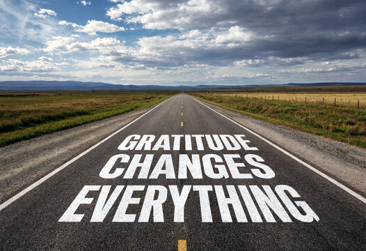 Inspirational road with gratitude changes everything message leading to open landscape and sky
