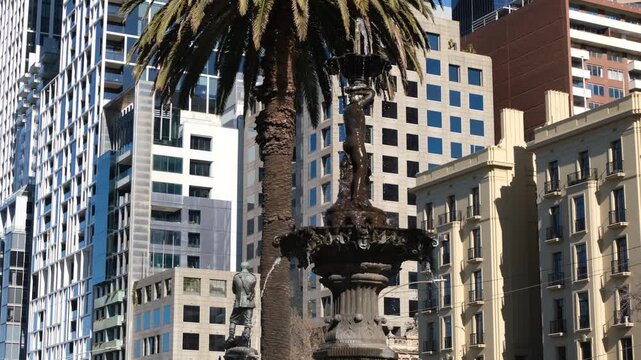 The historic Stanford Fountain, installed in 1871 on Spring Street, Melbourne, Australia, contrasting historic and modern high-rise buildings in the background. Old and new, heritage and modern CBD.