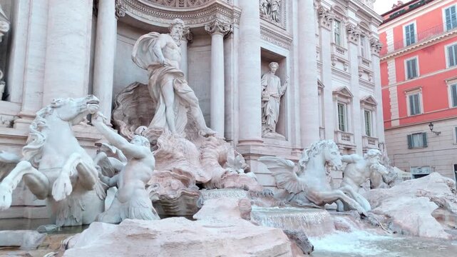 Trevi Fountain&rsquo;s Oceanus figure, tritons, and rearing sea horses rise above the rocky basin as the camera drifts in from above.