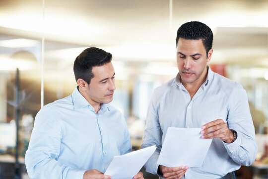 Business, paperwork or men with advice in meeting for internal audit, budget review or accuracy. Opinion, auditor or teamwork documents at accounting firm for bookkeeping, compare invoice or planning