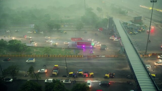 Heavy rain on a busy highway in India. Traffic moving through storm in Delhi NCR region.