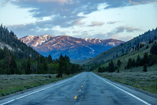 Empty highway 75 with mountains in distance at sunset