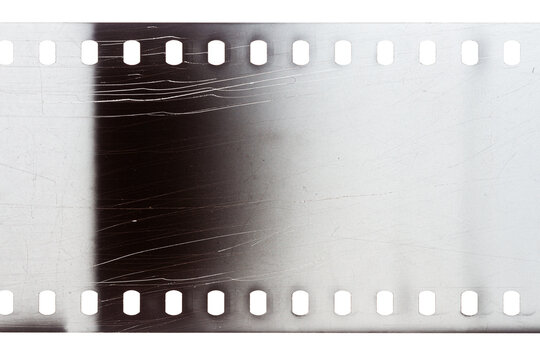 Dusty and grungy 35mm film texture or surface. Perforated scratched camera film isolated on white background.