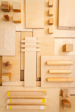 Flat lay of various wood and plywood pieces. Carpentry background.