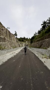 Slow Motion of Man Running on a Winding Road