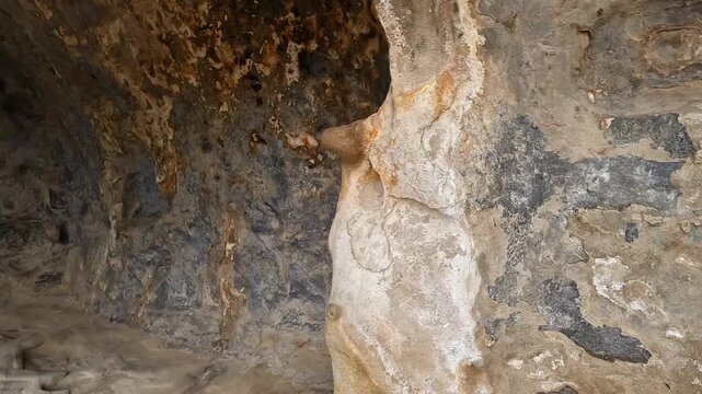 A carved interior chamber contains a wall niche and floor opening inside Uplistsikhe, Georgia, documenting ancient spatial planning for archaeology, museum education, conservation