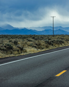 Dramatic sky above empty highway and mountains