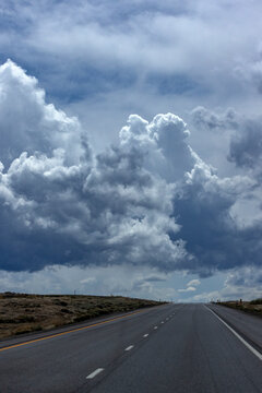 Dramatic sky above empty desert highway