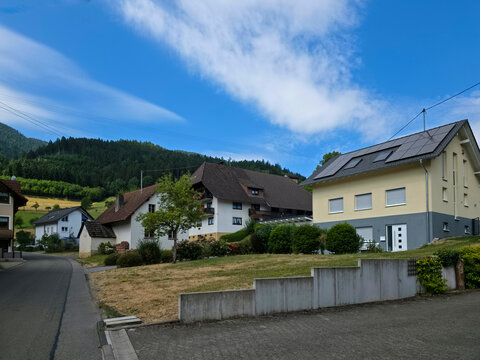 germany, tranquil countryside street through charming simonswald village surrounded by spectacular black forest scenery beneath crystal clear summer blue sky