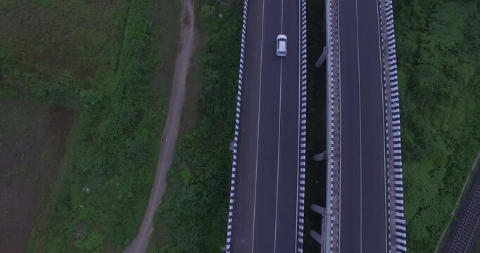 Aerial view of car driving on modern highway or expressway