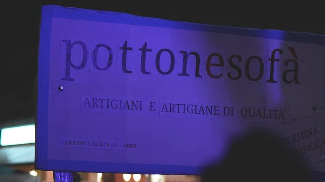 Viareggio, Italy - February 15, 2026: Provocative humorous signs on Viareggio promenade during lively Carnival celebration