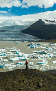 Hiker Overlooking Iceland Glacier and Glacial Lagoon from Above