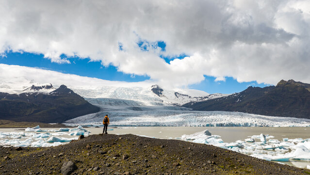 Hiker Overlooking Iceland Glacier and Glacial Lagoon from Above