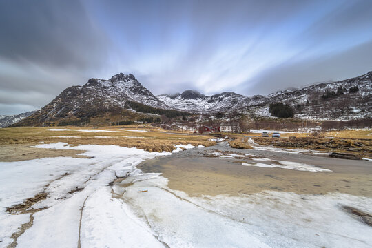 Ice structures glowing in last sunlight in sandy bay fjord Vareid