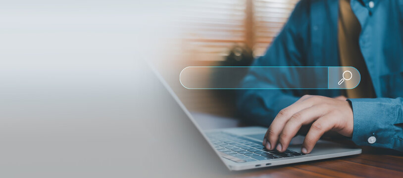 Online search interface on laptop with search bar and magnifying glass icon, representing web search, SEO optimization, information discovery, digital marketing, internet browsing search technology.