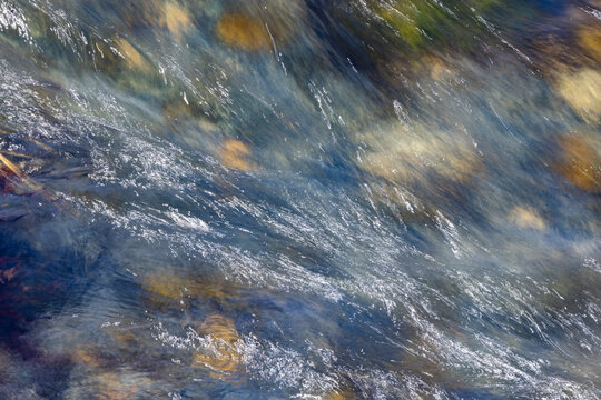 Close-up of pristine mountain creek water, motion blur