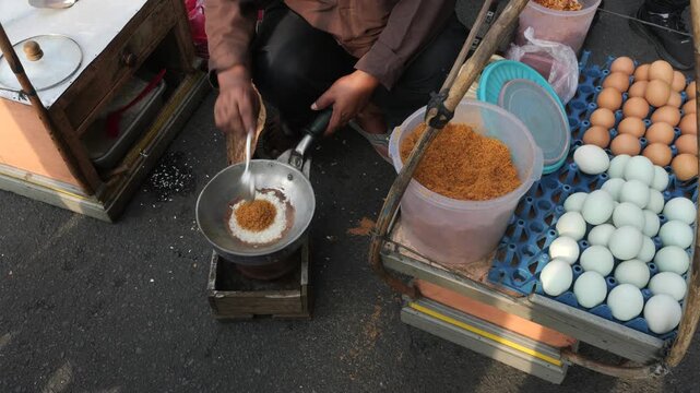 Fresh chicken eggs are added to glutinous rice during the preparation of Kerak Telor. The eggs bind the ingredients together while contributing richness, flavor, and the distinctive texture.