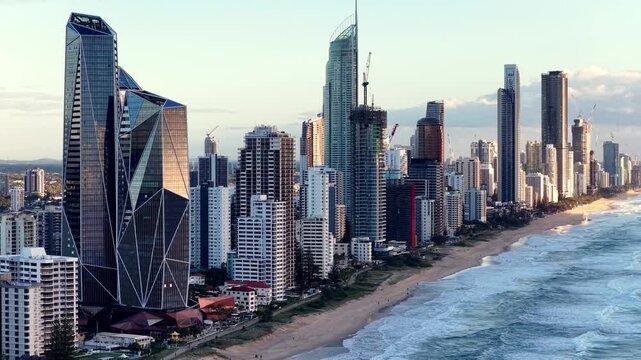 Slow aerial flying at Gold Coast surfers paradise waterfront of Australia Pacific ocean city.