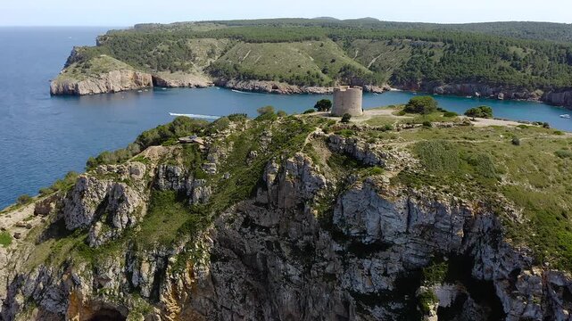 Aerial View of medieval watchtower of Cala Montgo, Anchorage and Turquoise Waters, Costa Brava, Spain. 