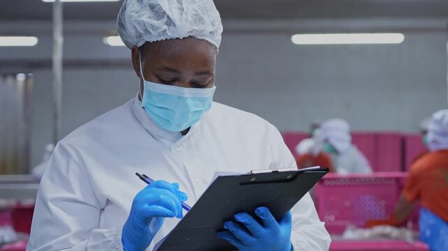 Female quality control in seafood processing plant, Food factory workers inspecting products on production line, Industrial food manufacturing facility with staff monitoring production quality