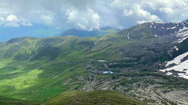 All three Abudelauri Lakes spread across a Caucasus panorama below snow-lined ridges, presenting a complete alpine destination for regional tourism, trekking itineraries, conservation