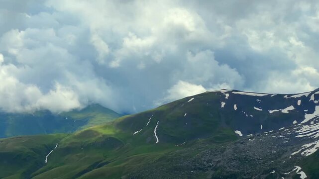 Dense clouds build above the Caucasus ridges near Abudelauri, transforming the summer highlands into a weather-driven scene for meteorology, climate monitoring, travel safety, and storm forecasting.