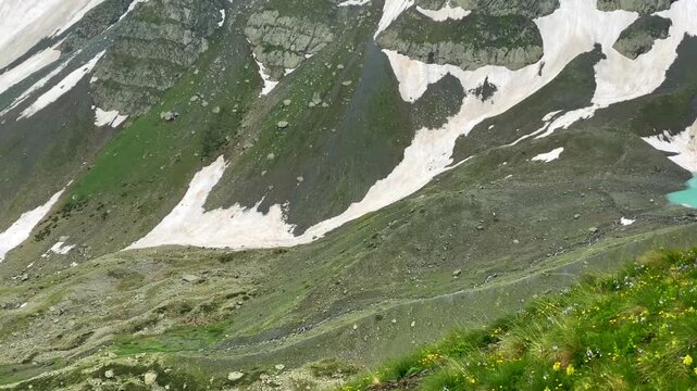 Three Abudelauri Lakes spread across a high Caucasus basin in northern Georgia, connecting turquoise glacial water, rocky terrain and green slopes for regional tourism mapping and destination