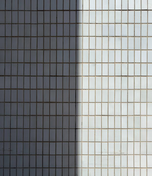 Geometric tile wall divided by strong light and shadow