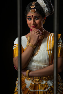 Mohiniattam dancer looking outside the window in a wondrous manner