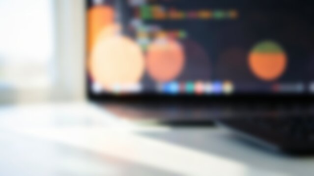 Blurred software code on laptop screen for tech website hero