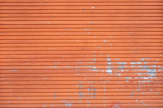 Close-up of old orange metal door