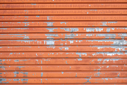 Close-up of old orange metal door