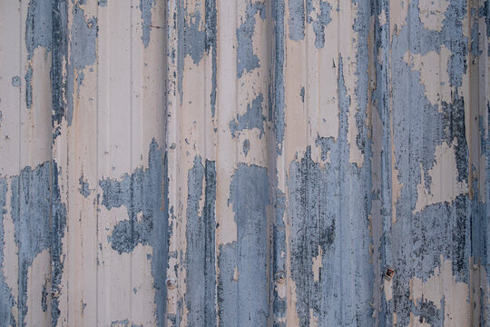 Close-up of metal wall with peeling paint