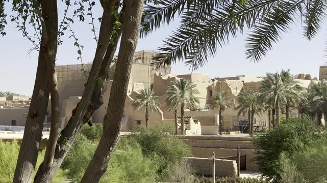DIRIYAH, SAUDI ARABIA - JULY 10, 2026: Historic At-Turaif district showcasing traditional mud-brick Najdi architecture and palm trees in Diriyah.