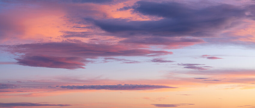 Pink and orange clouds against blue sky