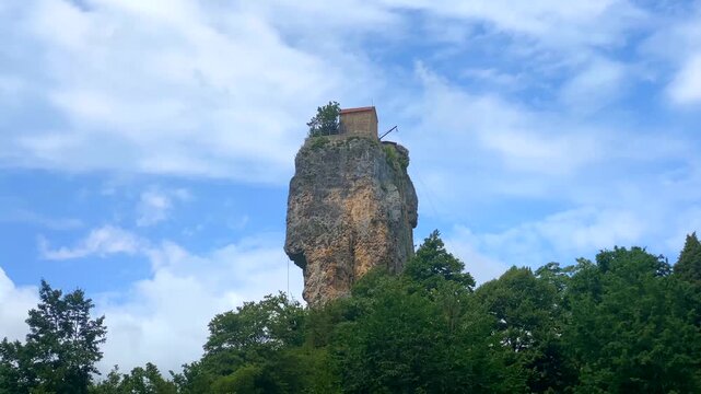 Katskhi Pillar rising above forested hills in Georgia supports destination marketing, religious heritage education and regional tourism through its remote monastery and distinctive limestone formation