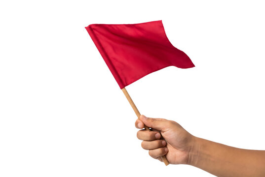 Person holding red flag for stop signal outdoors during day, attention warning caution symbol, sports event referee game official sign, danger alert communication concept.