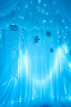 Magical Blue Winter Wonderland Photo Zone with Drapes and Lights