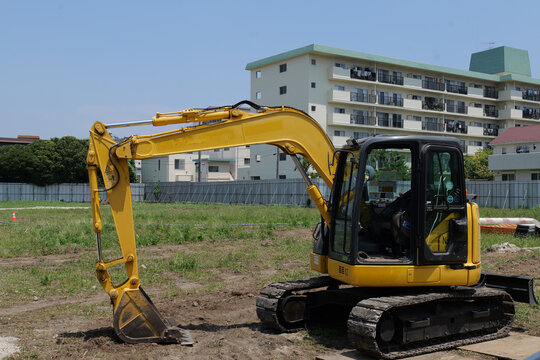 Bulldozer leveling and grading soil at a construction site before foundation work. Heavy construction equipment preparing the ground for residential or commercial development.