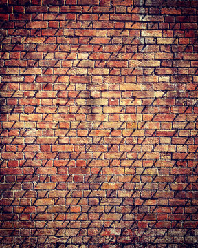 Full frame close up texture of old rustic red brick wall.